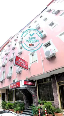 a large pink building with a hotel at HOTEL ÖZSEFA in Istanbul
