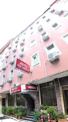 a pink building with a hotel at HOTEL ÖZSEFA in Istanbul