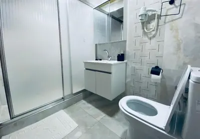 a bathroom with a toilet and a sink and a shower at HOTEL ÖZSEFA in Istanbul
