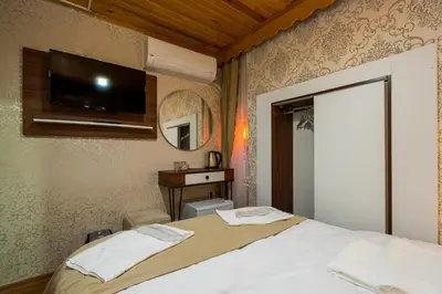 a bedroom with a bed and a tv on the wall at Candy Boutıque in Istanbul
