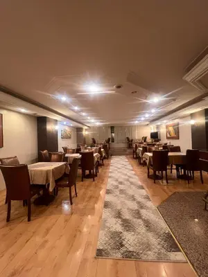 a restaurant with tables and chairs in a room at SEFA HOTEL 1 ÇORLU in Corlu