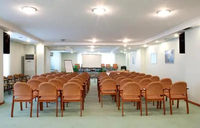 a room with a bunch of chairs and a screen at SEFA HOTEL 1 ÇORLU in Corlu