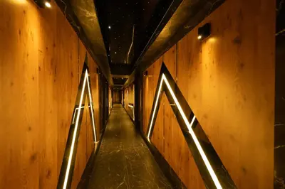 a hallway with wooden walls with lights on it at MQ Hotel Suites & SPA in Arnavutköy