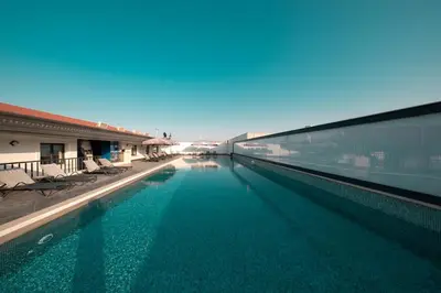 a large swimming pool next to a building at MQ Hotel Suites & SPA in Arnavutköy