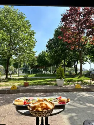 two plates of food on a table in a park at AVRASYAQUEEN HOTEL in Istanbul