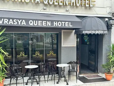 a restaurant with tables and chairs in front of a building at AVRASYAQUEEN HOTEL in Istanbul
