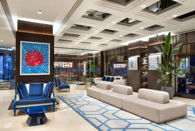 a lobby with couches and chairs in a store at TRYP By Wyndham Istanbul Sisli Hotel in Istanbul