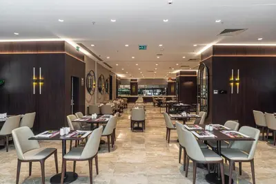 a restaurant with tables and chairs in a room at TRYP By Wyndham Istanbul Sisli Hotel in Istanbul