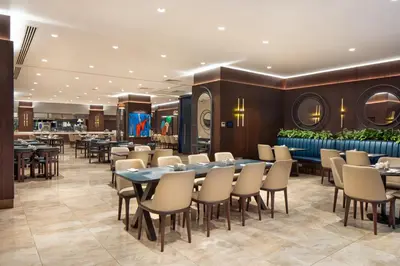 a restaurant with tables and chairs and a bar at TRYP By Wyndham Istanbul Sisli Hotel in Istanbul