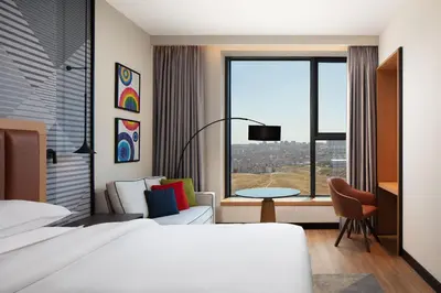 a hotel room with a bed and a large window at Sheraton Istanbul Esenyurt in Istanbul
