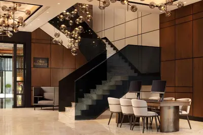 a staircase in a lobby with a table and chairs at Sheraton Istanbul Esenyurt in Istanbul