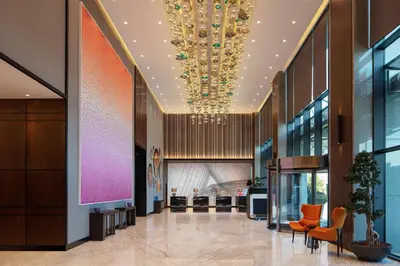 a lobby of a building with a chandelier at Sheraton Istanbul Esenyurt in Istanbul