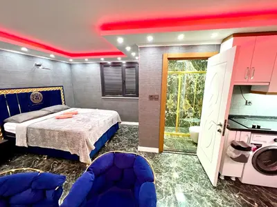 a bedroom with a bed and a bathroom with a sink at LEVENT PALACE REZİDANS in Istanbul