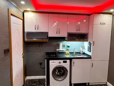 a kitchen with a washer and a red ceiling at LEVENT PALACE REZİDANS in Istanbul