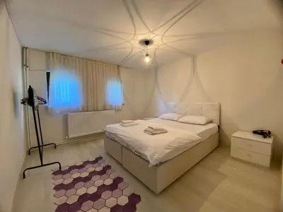 a white bedroom with a bed and a window at Maşukiye Home Suit Apart in Kartepe