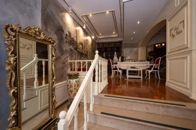 a hallway with a mirror and a dining room at Fuat Bey Palace Hotel & Spa in Istanbul
