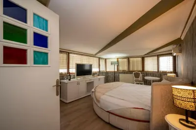 a bedroom with a large bed and a television at Fuat Bey Palace Hotel & Spa in Istanbul