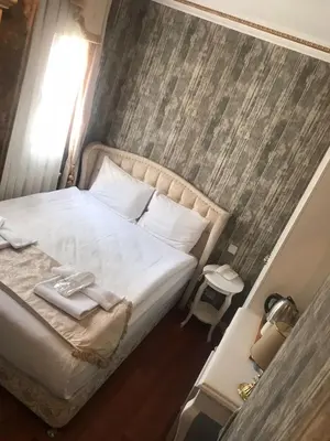 a bedroom with a bed with a tray of towels on it at Fuat Bey Palace Hotel & Spa in Istanbul