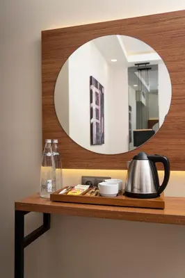 a mirror on a shelf with a tea kettle at Depiero Hotel Karaköy in Istanbul