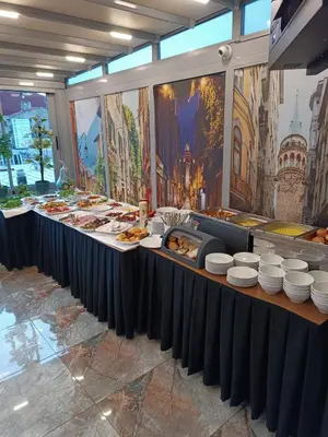 a buffet line with plates and food on at Bona Sera Hotel in Istanbul