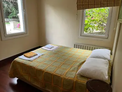 a small bedroom with a bed with two windows at Silivri Gazitepe'de 3 katlı, havuzlu lüks villa in Silivri