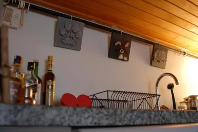 a kitchen counter with a bottle of wine and a sink at Duplex with terrace in center,5mn walk to Istiklal in Istanbul