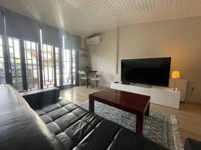 a living room with a couch and a flat screen tv at Duplex with terrace in center,5mn walk to Istiklal in Istanbul