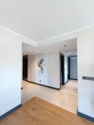 an empty living room with white walls and wood floors at Luxury Central Fully Equipped 3BR 2BA Apartment by Siena Suites in Istanbul