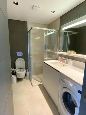 a bathroom with a washing machine and a toilet at Luxury Central Fully Equipped 3BR 2BA Apartment by Siena Suites in Istanbul