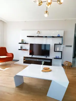 a living room with a white table and a tv at Luxury Fully Equipped 3BR 2BA Apartment by Siena Suites in Istanbul