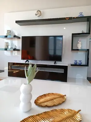 a living room with a television and a vase on a table at Luxury Fully Equipped 3BR 2BA Apartment by Siena Suites in Istanbul