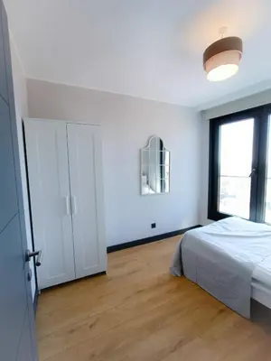 a white bedroom with a bed and a window at Luxury Fully Equipped 3BR 2BA Apartment by Siena Suites in Istanbul