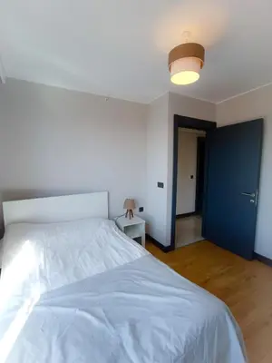 a bedroom with a white bed and a blue door at Luxury Fully Equipped 3BR 2BA Apartment by Siena Suites in Istanbul