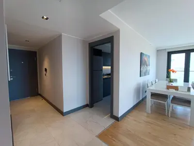 a living room with a table and a window at Luxury Fully Equipped 3BR 2BA Apartment by Siena Suites in Istanbul