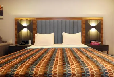 a bedroom with a large bed with a colorful bedspread at İncipark Hotel in Sakarya