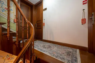 a hallway with a wooden staircase with a rug at Valeria Antique 1892 in Istanbul