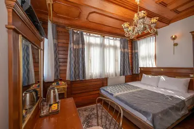 a bedroom with a bed and a table and a chandelier at Valeria Antique 1892 in Istanbul