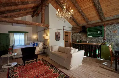 a living room with a couch and a bed at Dachas Cove Hotel in Agva