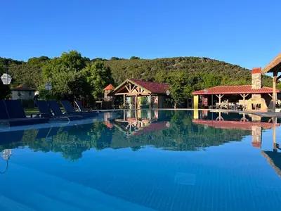 a large swimming pool with chairs and a resort at Dachas Cove Hotel in Agva