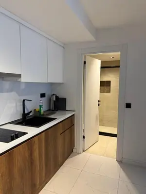 a kitchen with white cabinets and a sink at City Aparts Nisantasi in Istanbul