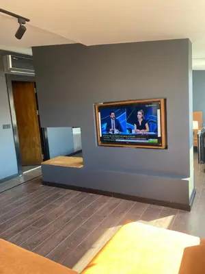 a living room with a flat screen tv on a wall at City Aparts Nisantasi in Istanbul