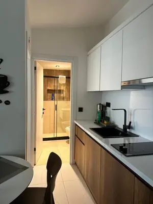 a kitchen with white cabinets and a counter top at City Aparts Nisantasi in Istanbul