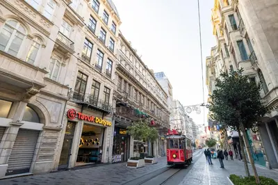 a red trolley on a city street with buildings at Upside Apartments in Istanbul