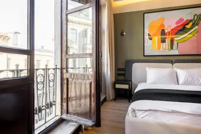 a hotel room with a bed and a balcony at Upside Apartments in Istanbul
