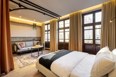 a bedroom with a bed and a couch and windows at Upside Apartments in Istanbul