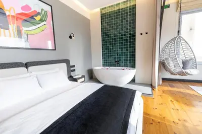 a bedroom with a bed and a bath tub and a sink at Upside Apartments in Istanbul