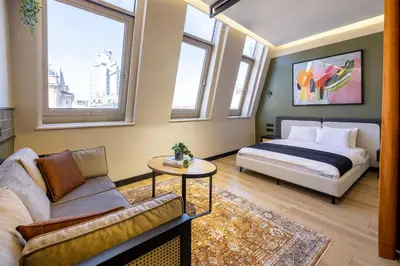 a bedroom with a bed and a couch and windows at Upside Apartments in Istanbul