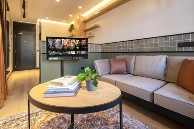 a living room with a couch and a table with books at Upside Apartments in Istanbul