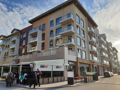 a building on a street with people walking in front of it at New Inn Hotel Cadde 54 Mall in Sakarya