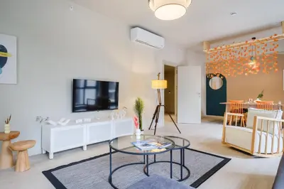 a living room with a table and a tv at New Inn Hotel Cadde 54 Mall in Sakarya